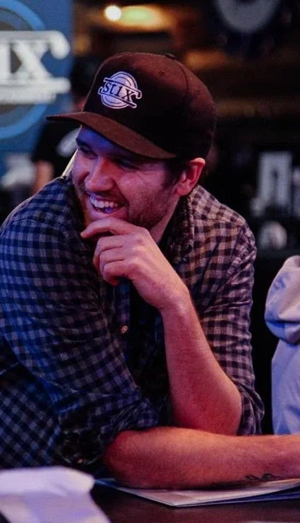 Friends laughing together over drinks at Stix
